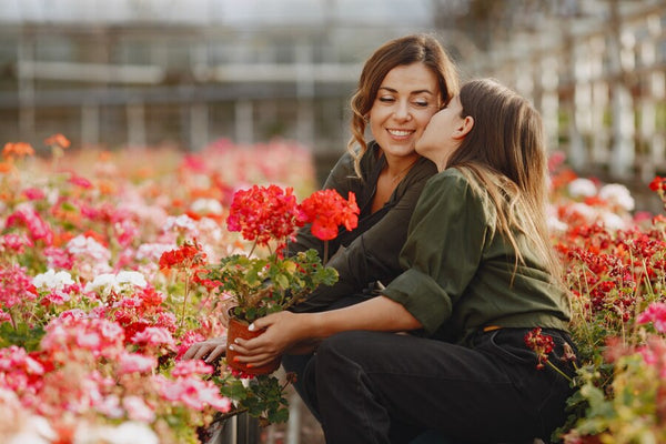 Woman and young girl in greenhouse